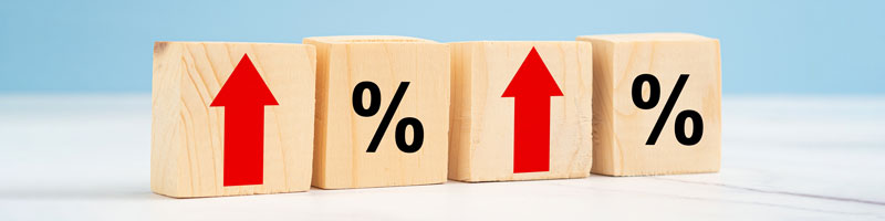 Row of wooden blocks with alternating arrows and percentage signs.